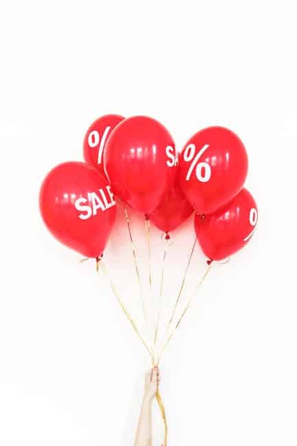 Red balloons with white SALE signs perfect for promotional marketing materials.